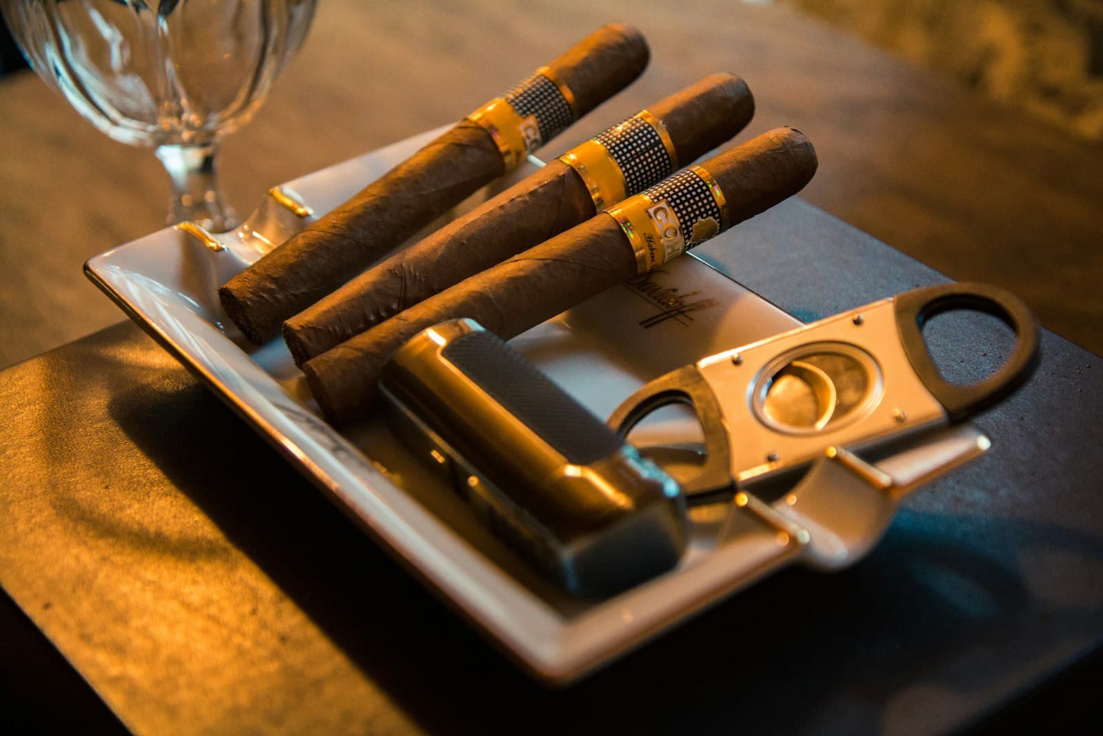 Cigars and a cutter arranged as warm event mood