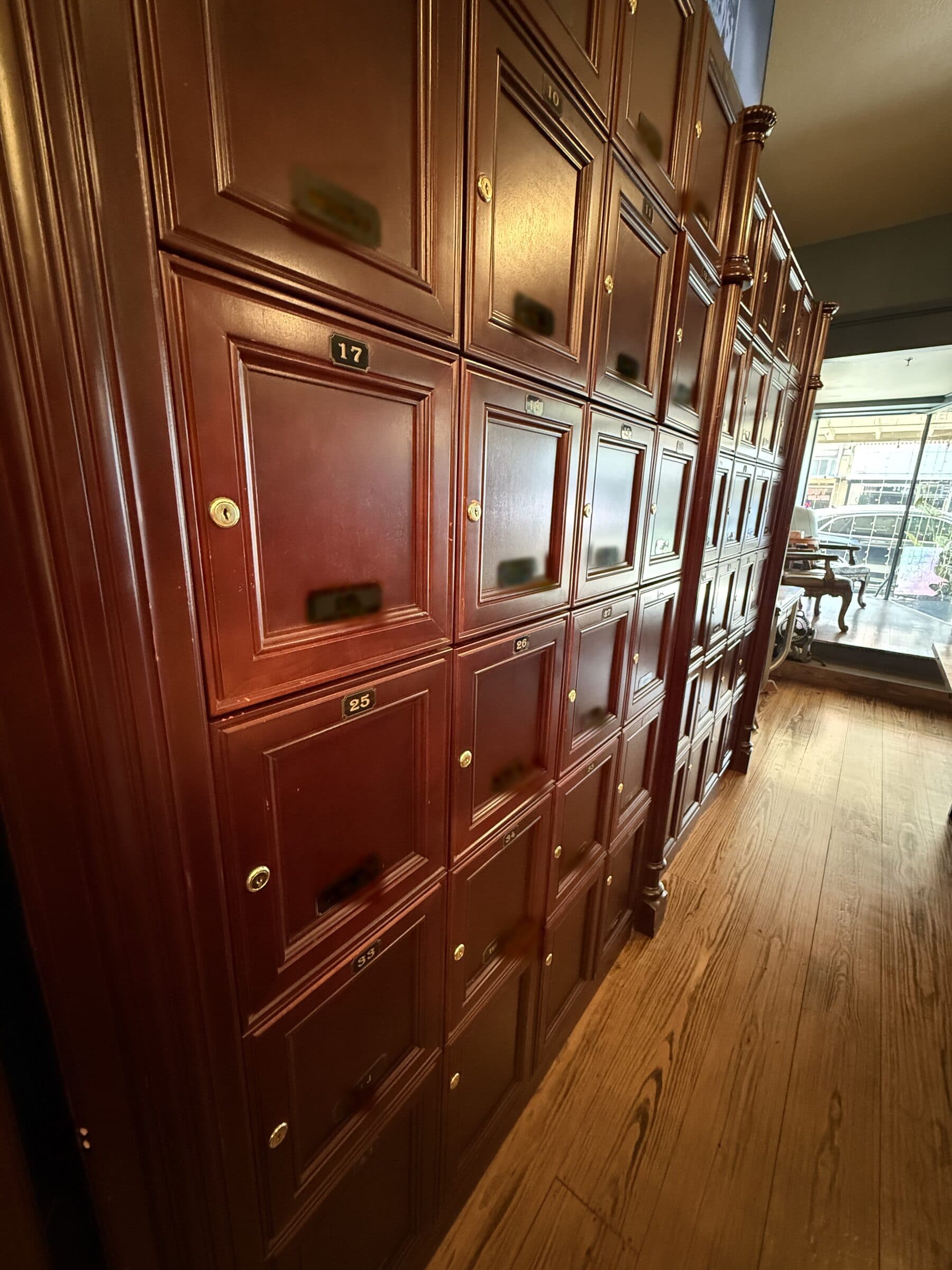 The mahogany locker wall at Big Chief, with a brass number on each door