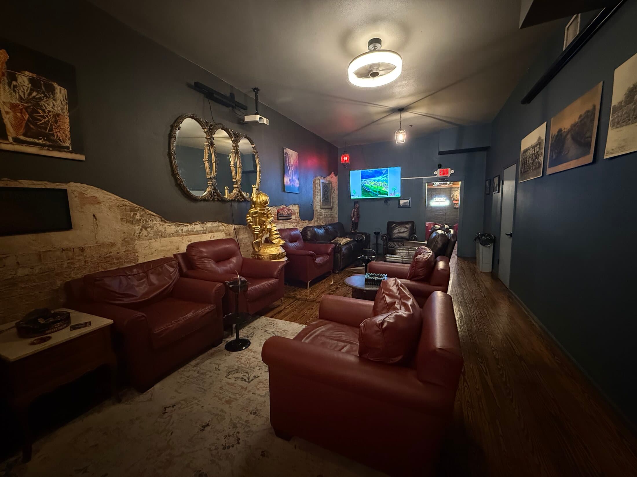 Oxblood leather chairs, exposed brick, and warm lamplight inside the lounge