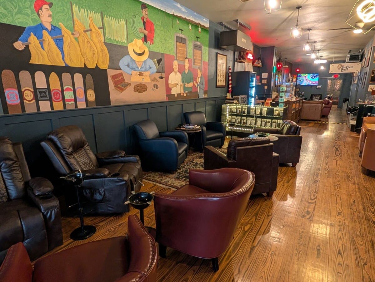 A hand-painted mural of tobacco farming and cigar rolling above the lounge chairs